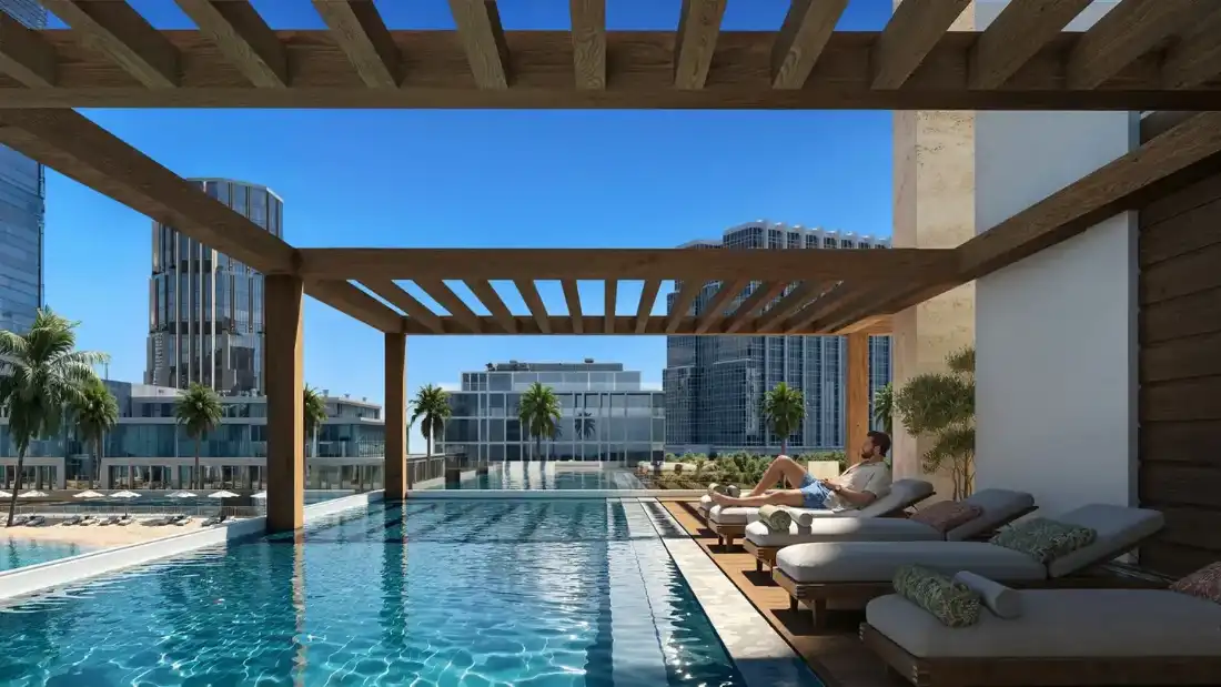 Époque pool deck with pergola and city views