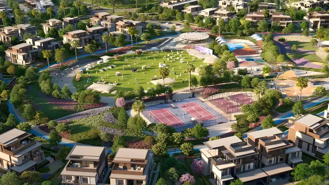 Aerial view of Nad Al Sheba Gardens villas around a central park with sports courts by Meraas